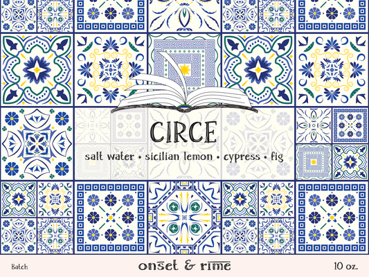 A close up view of the label for the Onset & Rime lemon, cypress scented candle called "Circe". The label is white with a dark blue Greek tile pattern. The text on the label is "Circe - Salt Water, Sicilian Lemon, Cypress, Fig".