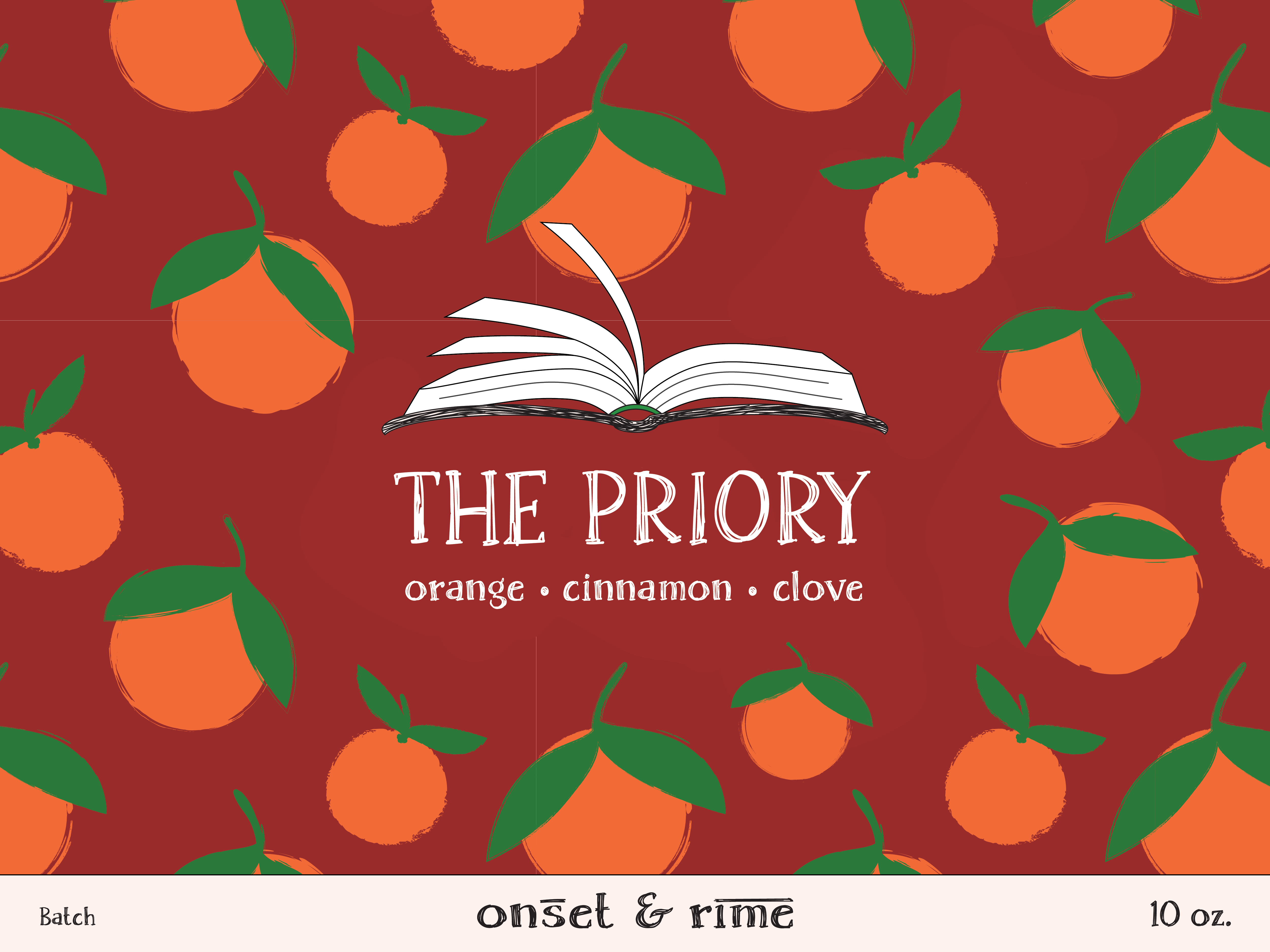 A close up view of the label for the Onset & Rime spiced orange scented candle called "The Priory". The label is red with a pattern of oranges. The text on the label is "The Priory - Orange, Cinnamon, Clove".